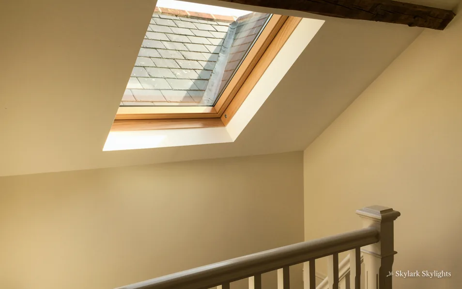 Stair rail at the top of a flight under a roof window