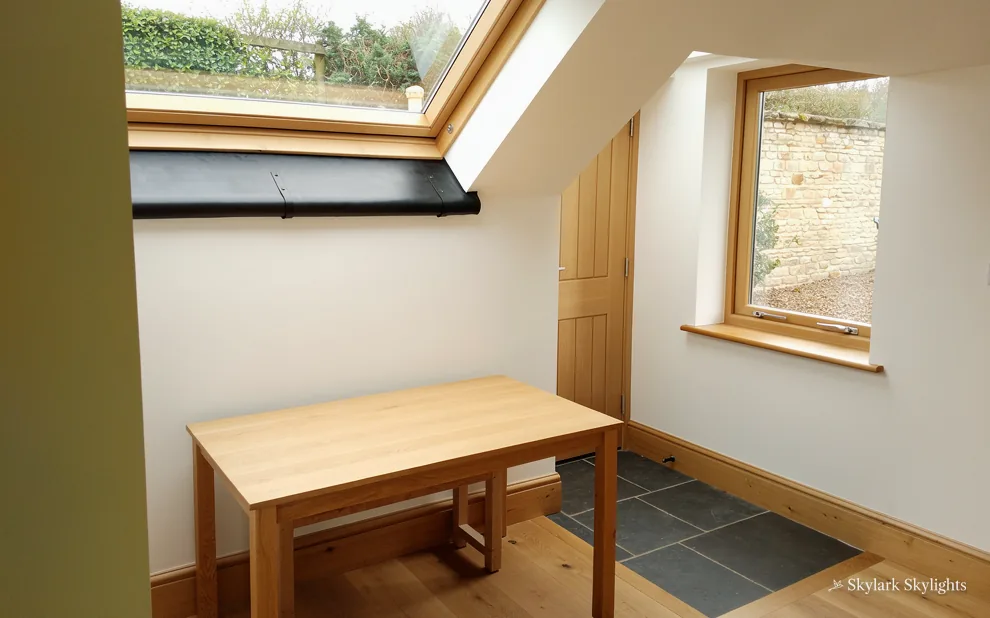 Small table in a loft room by a window