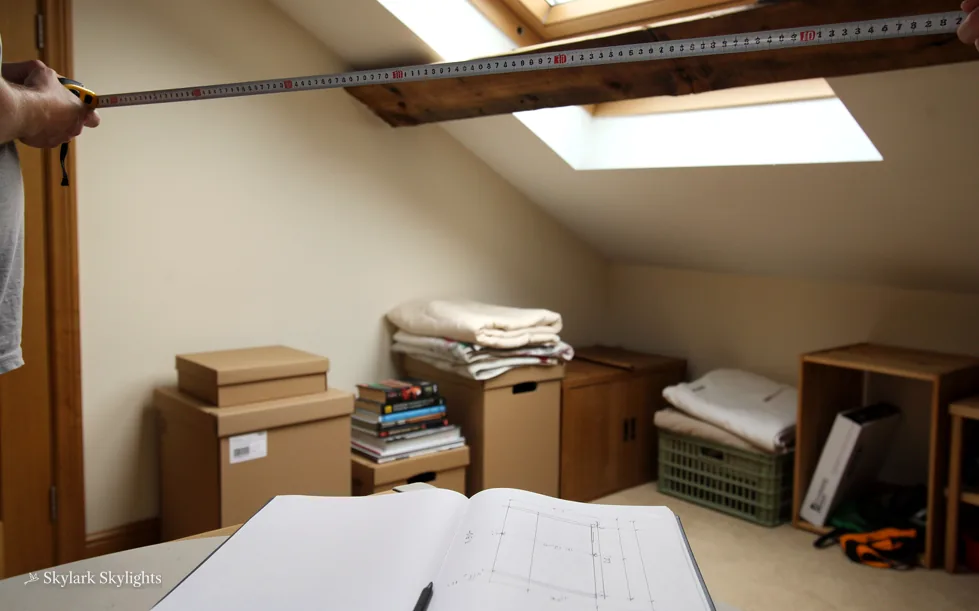 Loft room with boxes and stacked storage under a beam