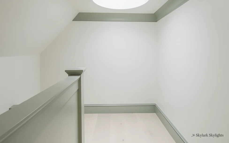Narrow landing with a grey-green balustrade