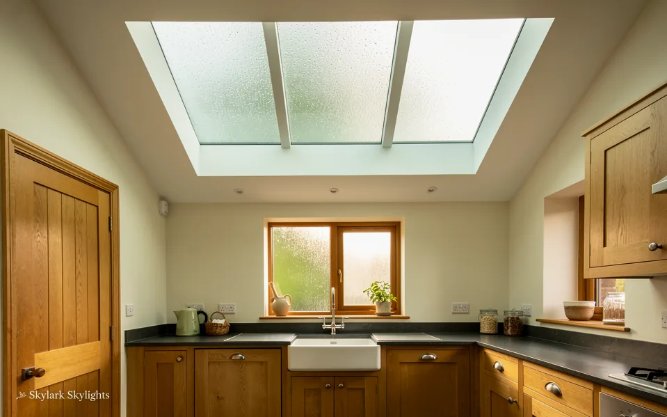 Back kitchen with wooden units and a frosted rooflight over the sink