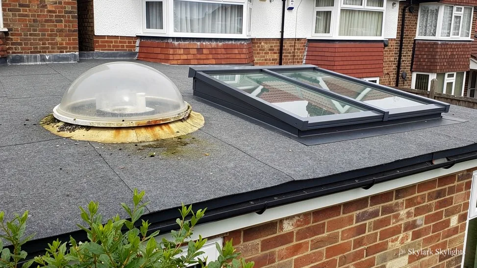Dome rooflight and a flat rooflight side by side on a brick extension