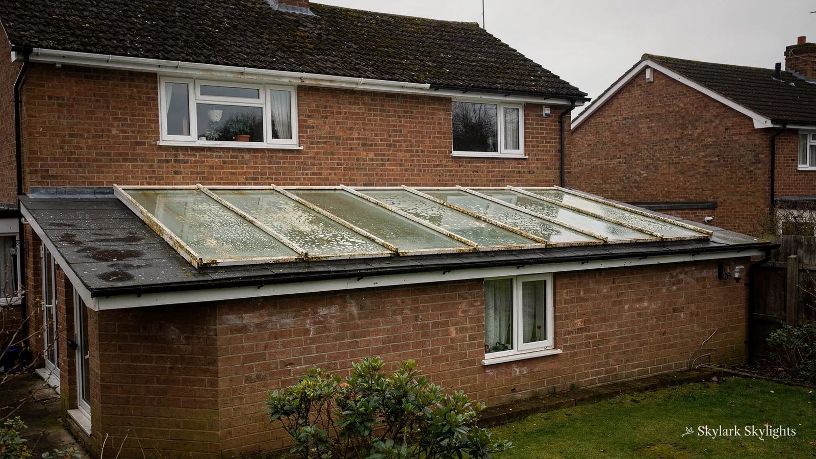 Brick extension with a long sloping glazed roof
