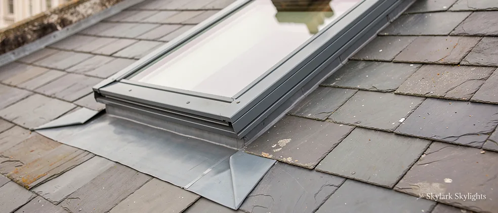 Slim rooflight sitting flush in a grey slate roof
