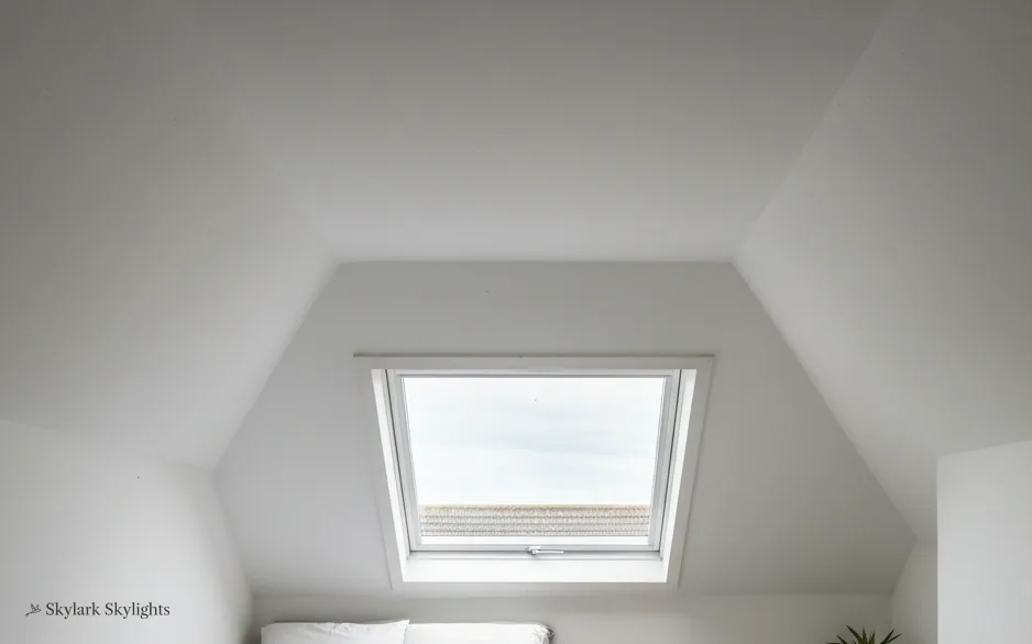 Small roof window in the slope of an empty attic