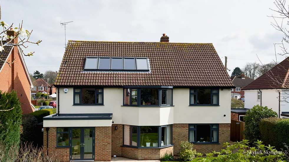 Rendered house with solar panels and roof windows