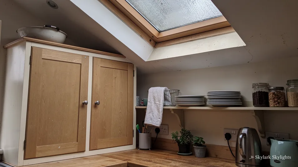 Loft storage with timber cupboards under an open roof window