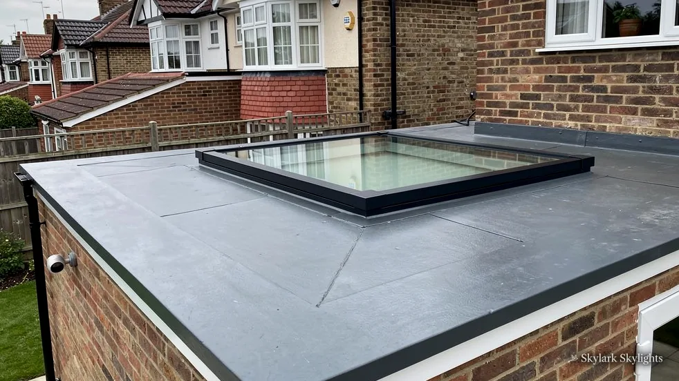 Flat rooflight on the roof of a brick rear extension between terraces