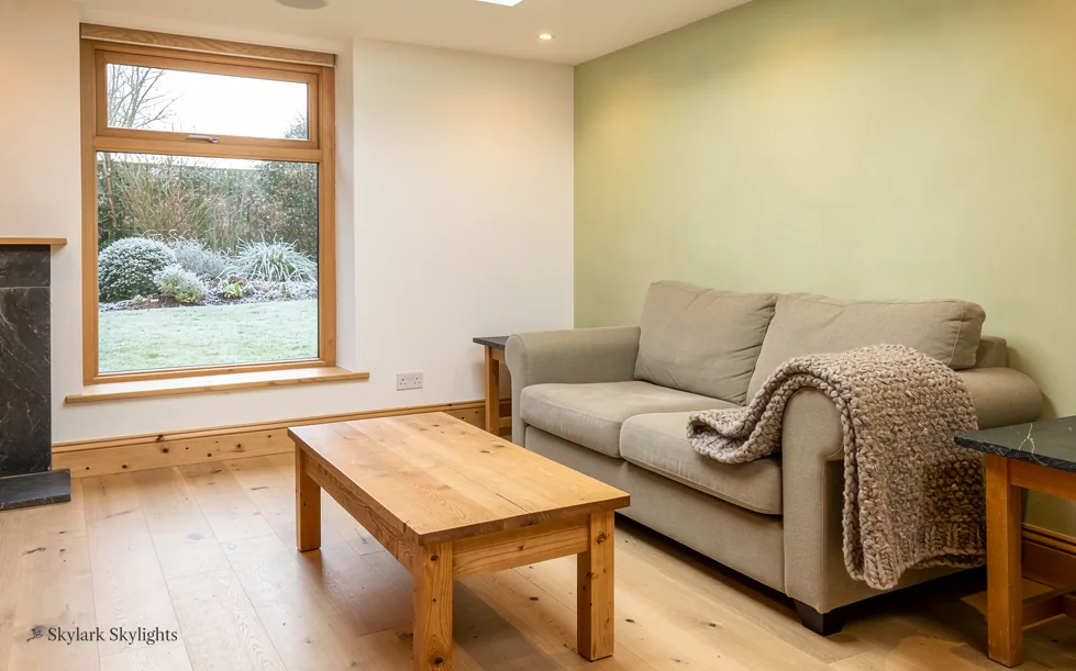 Sitting room with a sofa and coffee table by a garden window