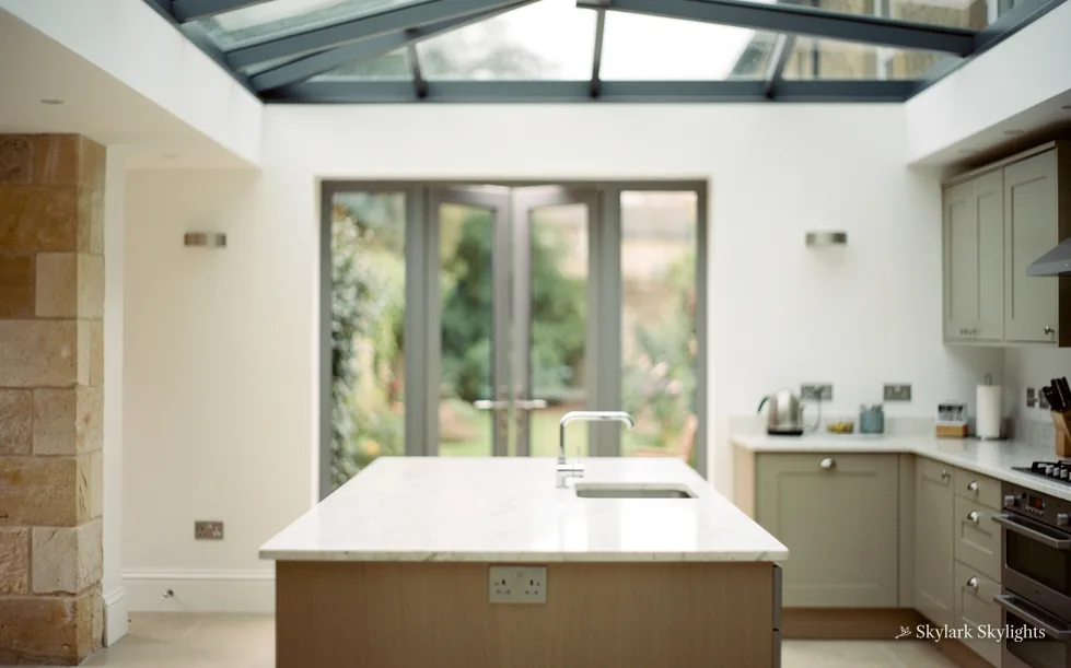 Kitchen island and garden doors under a roof lantern