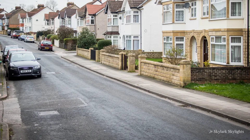 Street of brick semis with parked cars