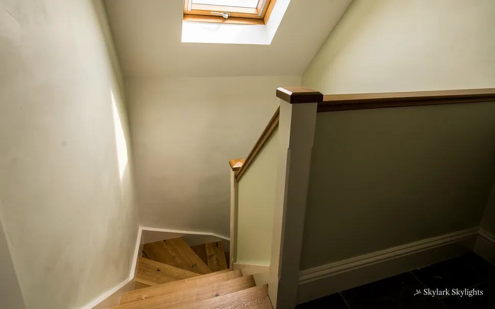 Turn of a staircase with a dark handrail