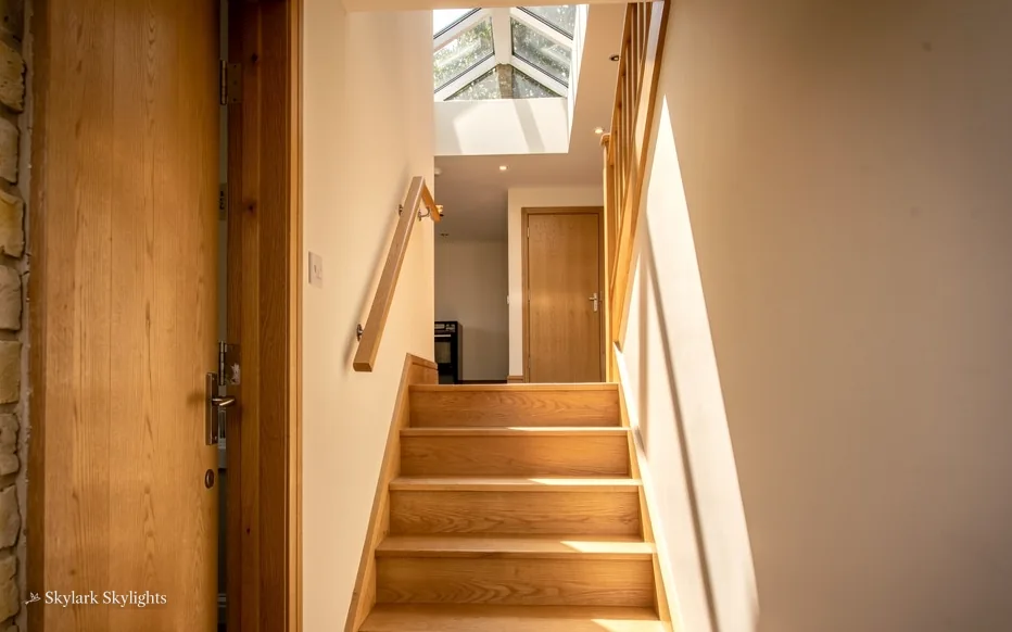Steep wooden stairs in a narrow stairwell