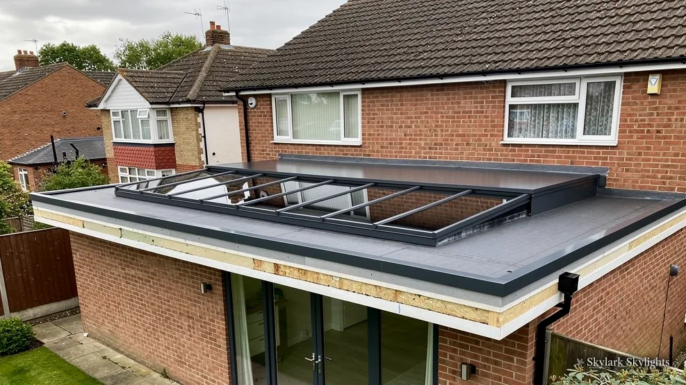 Brick house with a rear extension and rooflights, garden in front