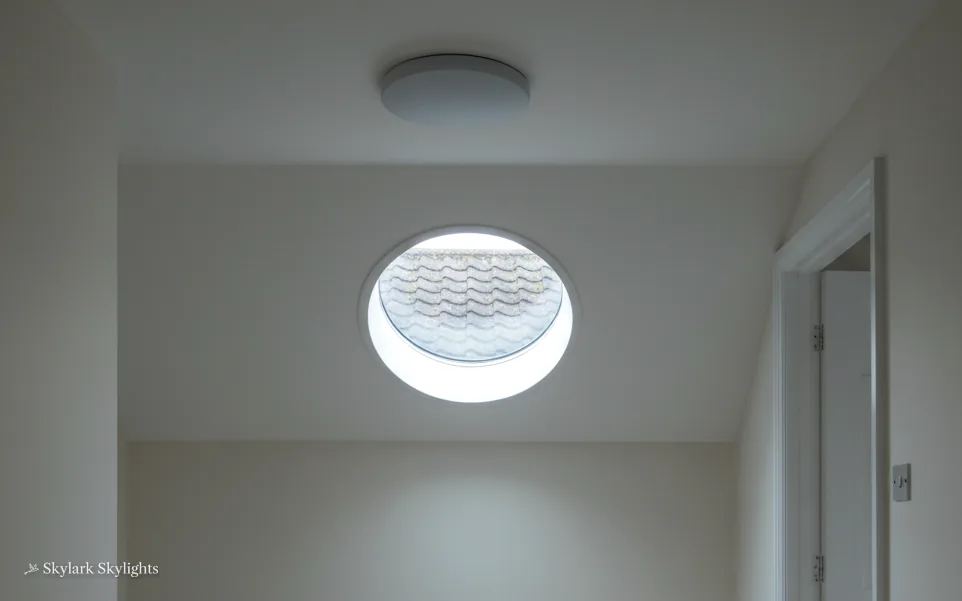Round window in a plain white wall