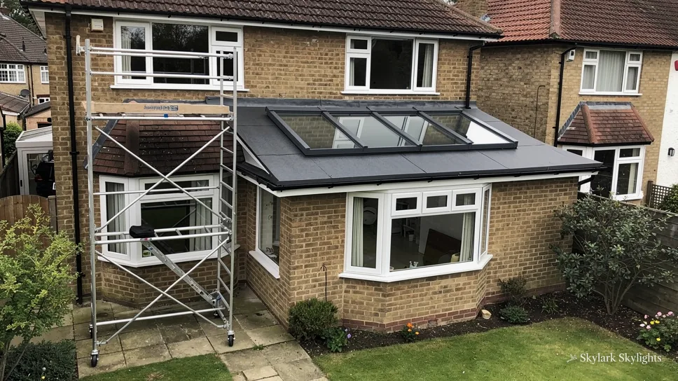 Brick house with a lean-to extension and scaffolding on the side