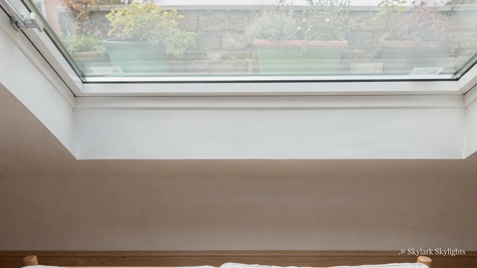 Rooflight above a white sofa with a hazy, clouded pane