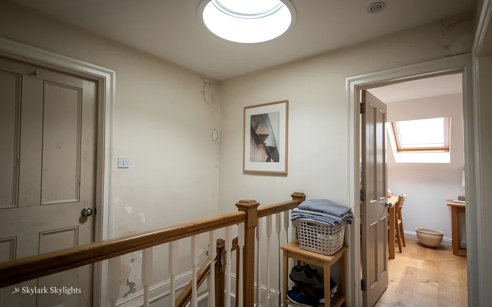 Landing with a wooden banister and doors to bedrooms