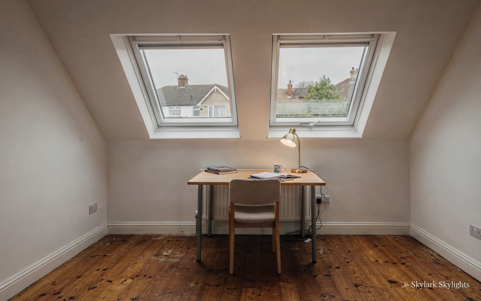 Small desk under roof windows in a loft room