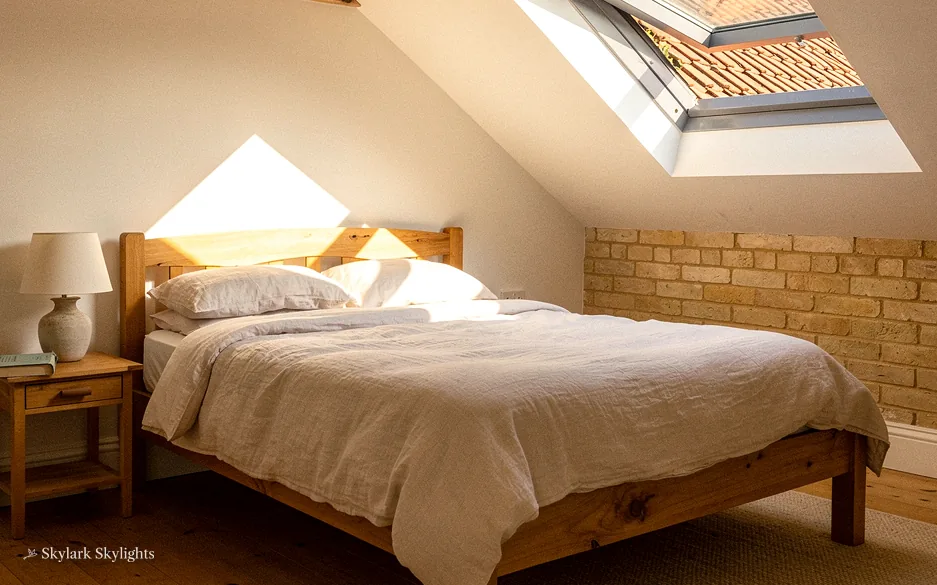Loft bedroom with a stone wall and a roof window