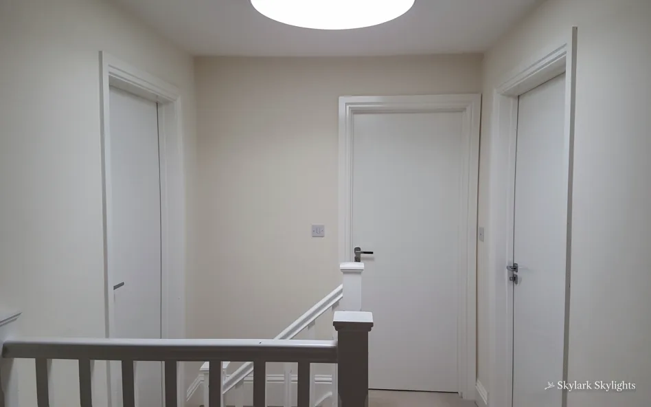Landing with doors off and a dark banister