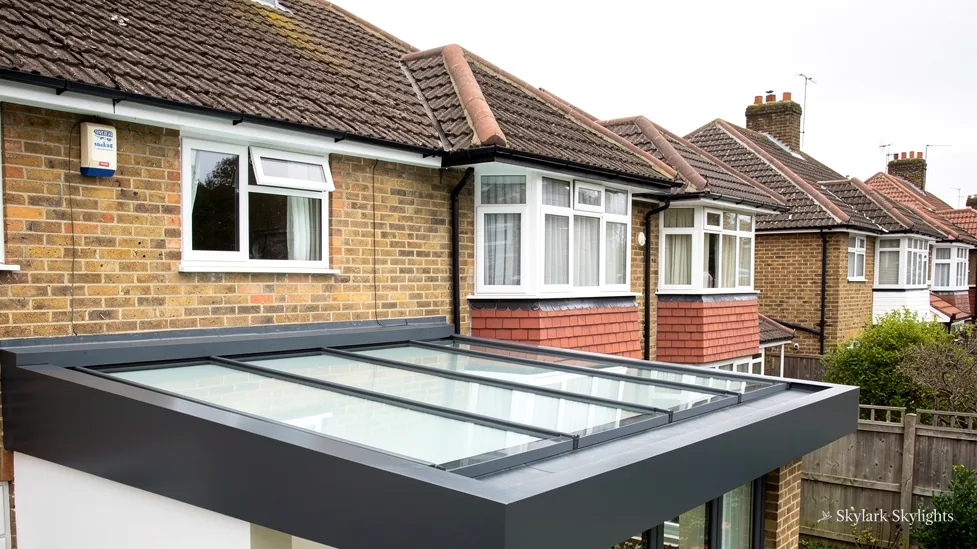 Flat rooflight on a single-storey extension below brick semis