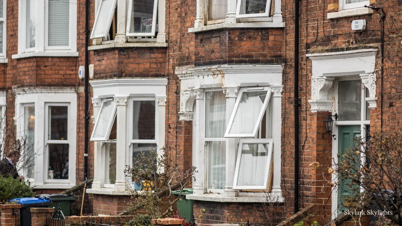 Victorian red-brick terraced house fronts with bay windows