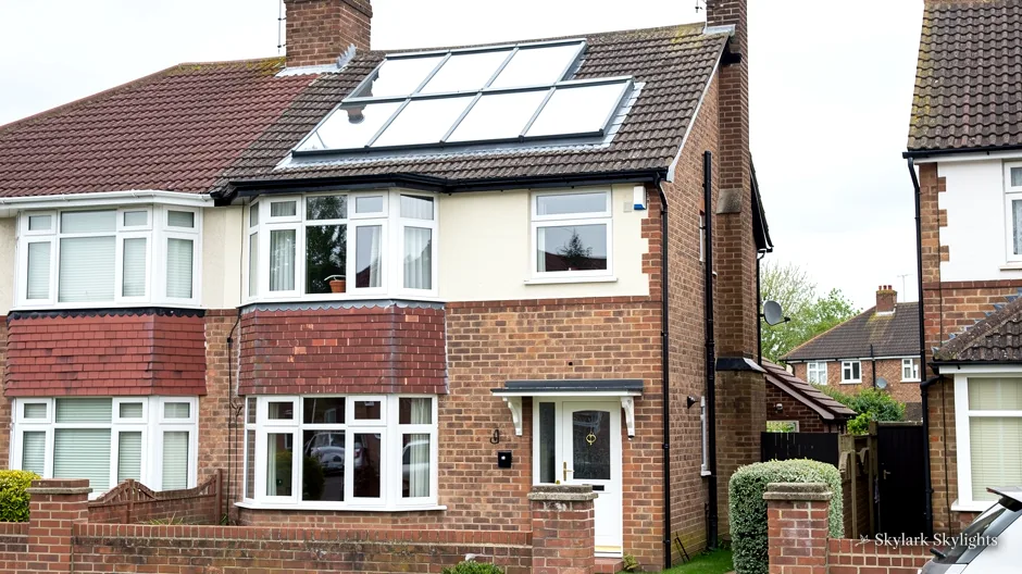 Brick semi with roof windows and a bay window