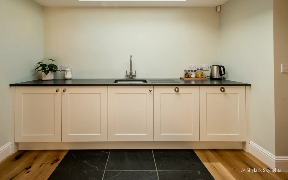 Galley kitchen units against a plain wall