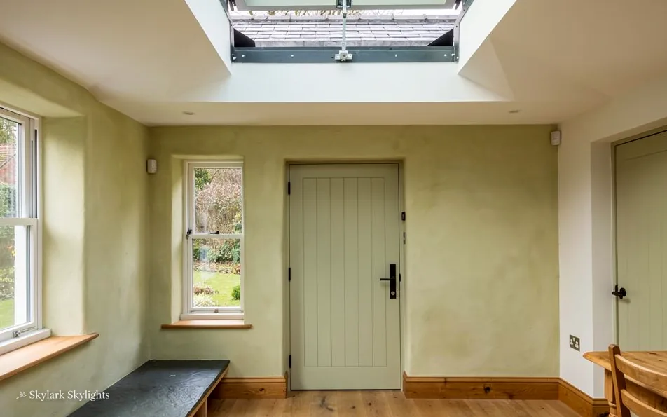 Hallway with a panelled door and a rooflight above