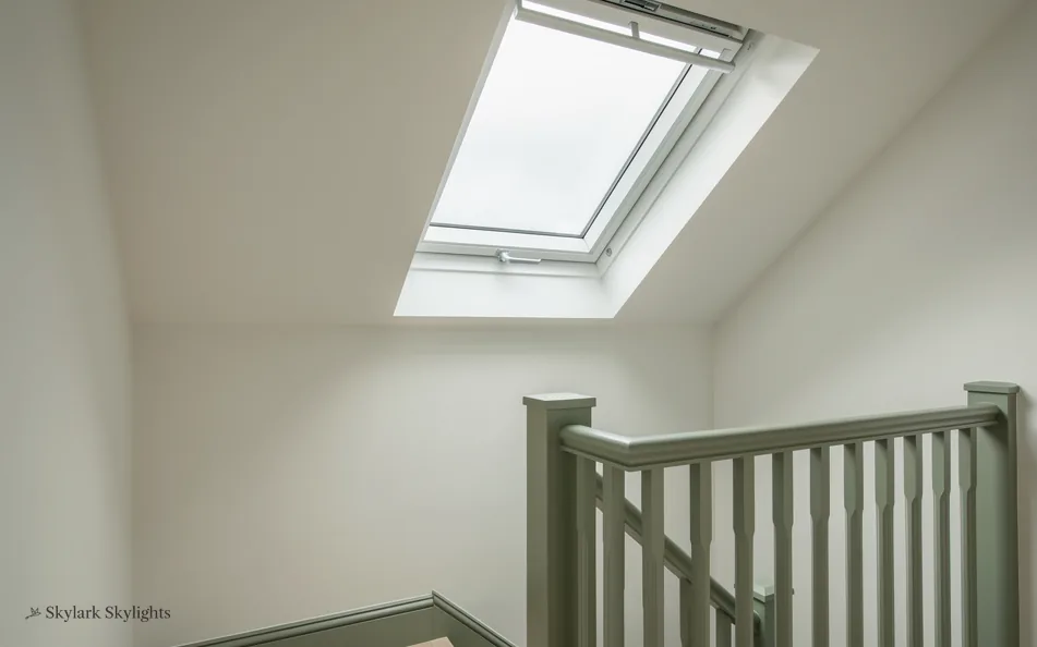 Landing with a green-painted balustrade under a roof window