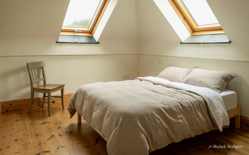 Attic bedroom with a chair and roof windows