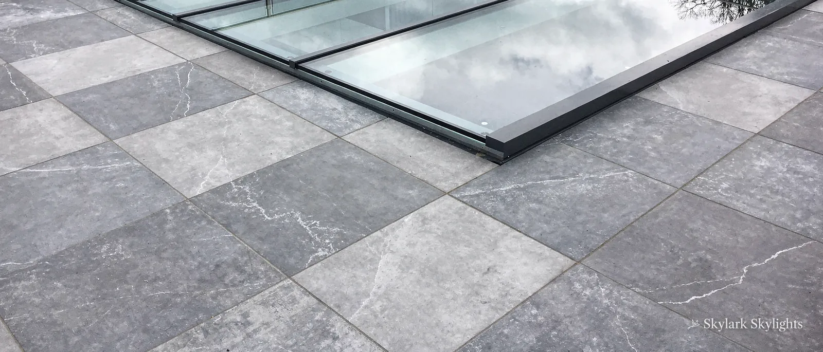Walk-on rooflight laid into grey stone paving
