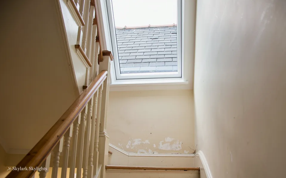 Stairs climbing under a roof window